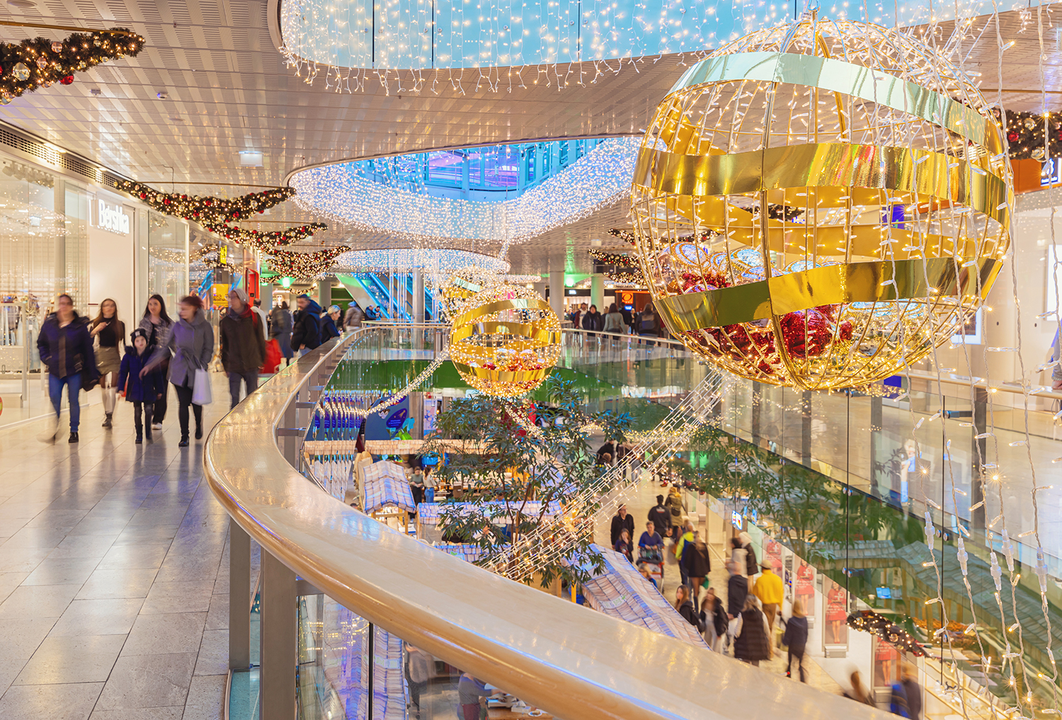 Festively decorated Europapark shopping center in Austria with Christmas lights, tree, and visitors enjoying the holiday atmosphere.